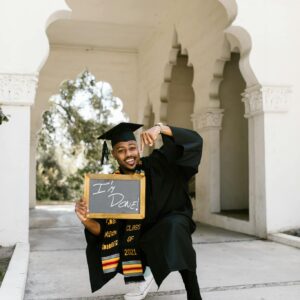 Woman in Academic Dress Holding Black Frame