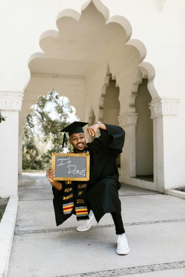 Woman in Academic Dress Holding Black Frame